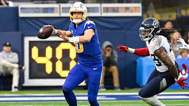 Dec 18, 2022; Inglewood, California, USA; Los Angeles Chargers quarterback Justin Herbert (10) throws a pass against Tennessee Titans linebacker Bud Dupree (48) during the first half of an NFL game against the Tennessee Titans at SoFi Stadium.